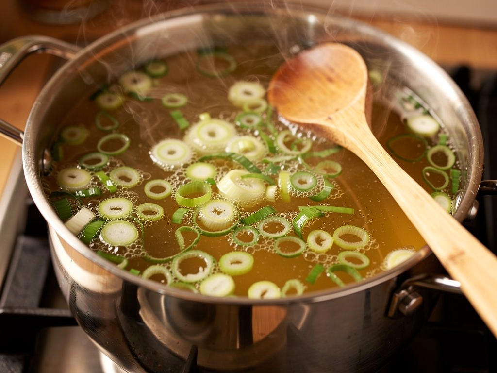 Letting the soup simmer to develop rich flavors.